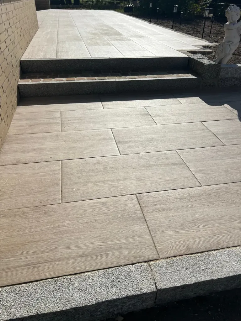 Terrasse aus großformatigen Platten mit Stufe