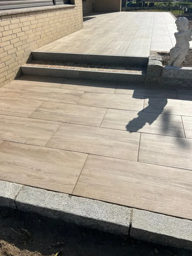 Terrasse aus Keramikplatten in Holzoptik mit Granitstufen